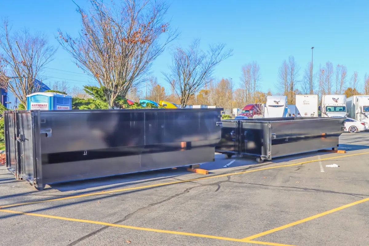 Professional dumpster rental service with roll-off container on residential driveway in High Point